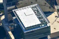 Aerial view of modern white TPO roof on Charlotte commercial building