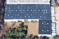 Aerial view of a dark-roofed commercial building in Grand Rapids