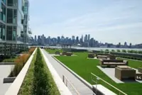 Green Rooftop Oasis with Seating, Overlooking NYC Skyline and Water