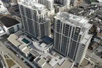 Aerial: High-rise commercial buildings with updated flat roofs in West Haven.