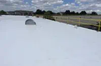 Flat white commercial rooftop with safety rails, dome structure in Chicago, IL