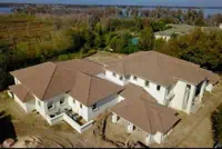 Aerial view of multi-story house with TPO roofing in Orlando, FL.