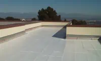 White-Covered Flat Roof with Beige Walls and Mountain View