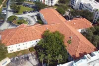 Aerial view of red-tiled commercial roofs in Orlando, FL complex.