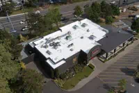 Aerial view of commercial building with white TPO roof in Portland, OR