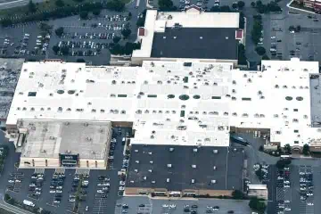 Aerial view of mall with white commercial roof near Francis Scott Key Park