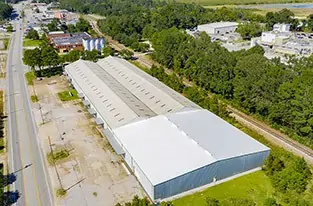 Aerial view of large warehouse with gray and white TPO roof in Mobile, AL