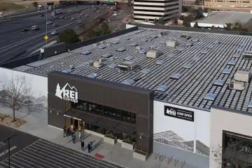 Aerial view of REI Co-op's solar-paneled roof in a commercial area