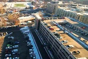 Aerial view of multi-level parking garage with solar panel roof installation.