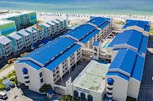 Aerial view of blue-roof beachfront hotel complex, Mobile, AL