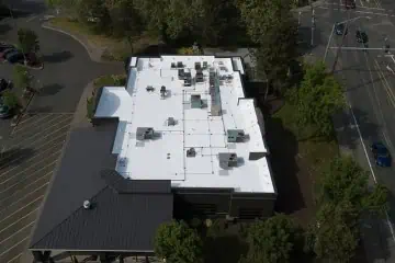 Aerial view of white flat-roof commercial building near Thirsty Lion, Portland OR