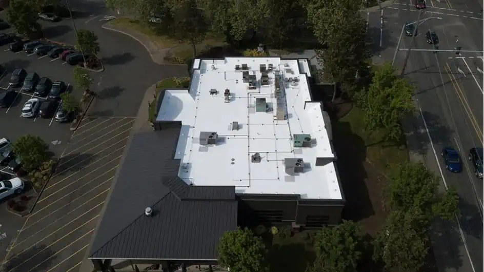 Aerial view of commercial building with white TPO flat roof in Portland, OR.