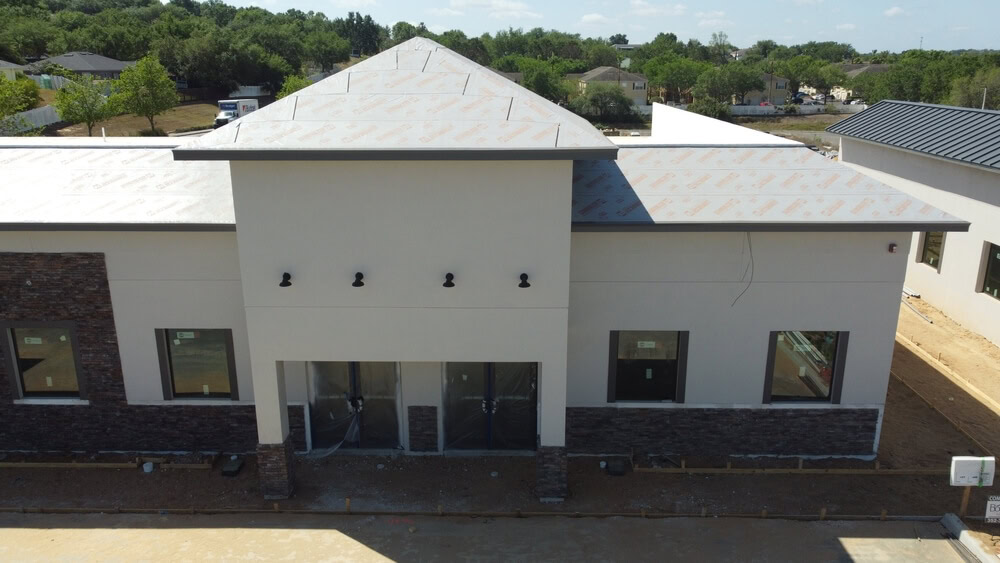 A new construction commercial building roof being installed.